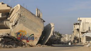  The word 'Steadfast' is seen as graffiti on a damaged building in Deraa [Wsam Almokdad/Reuters]
