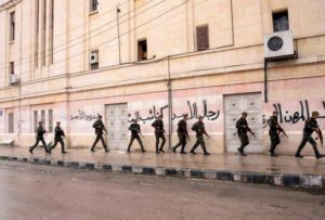 Soldiers loyal to Syrian President Bashar al-Assad patrol the streets in al-Sabaa Bahrat district, an area controlled by Free Syrian Army fighters, in the centre of Aleppo February 20, 2012. (REUTERS/George Ourfalian)