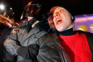 A Russian police officer detain an opposition activist during a protest against vote rigging in St. Petersburg, Russia, on December 4, 2011. (AP Photo/Dmitry Lovetsky)