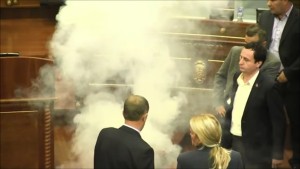 Party leader Albin Kurti and other representatives from Vetevendosje! release tear gas in the Kosovo parliament in protest at the Association.