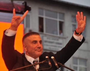 Sedat Peker addresses the crowd at an AKP rally, making the traditional ultranationalist gesture with his right hand.